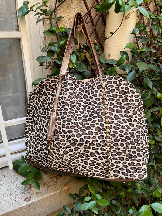 leopard leather tote bag beige background